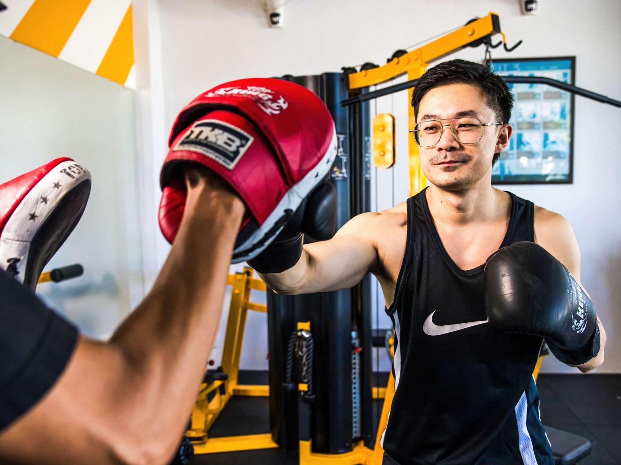 Grand Mercure Phuket Patong Ngoại thất bức ảnh A boxer training with a heavy bag